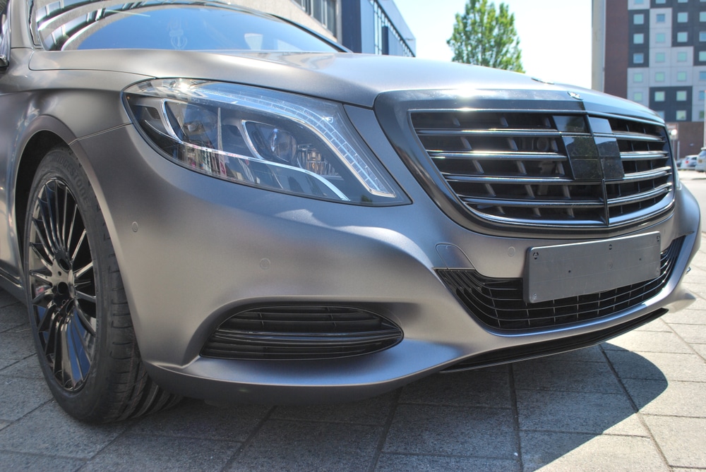 A front view of a matte metallic car wrapped in grey