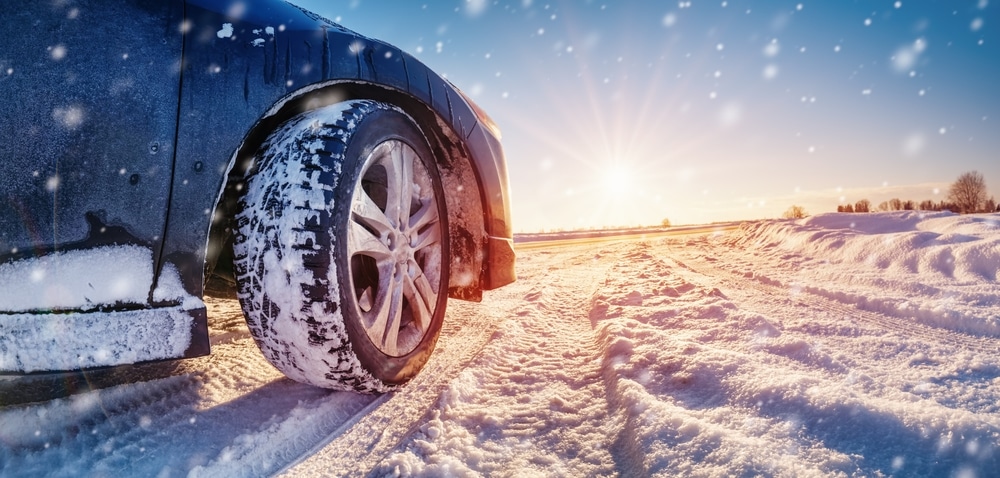 A rear side view of a car in snow