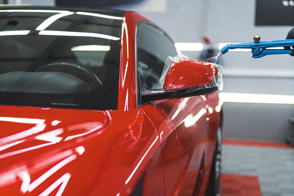 A view of car being wrapped in red