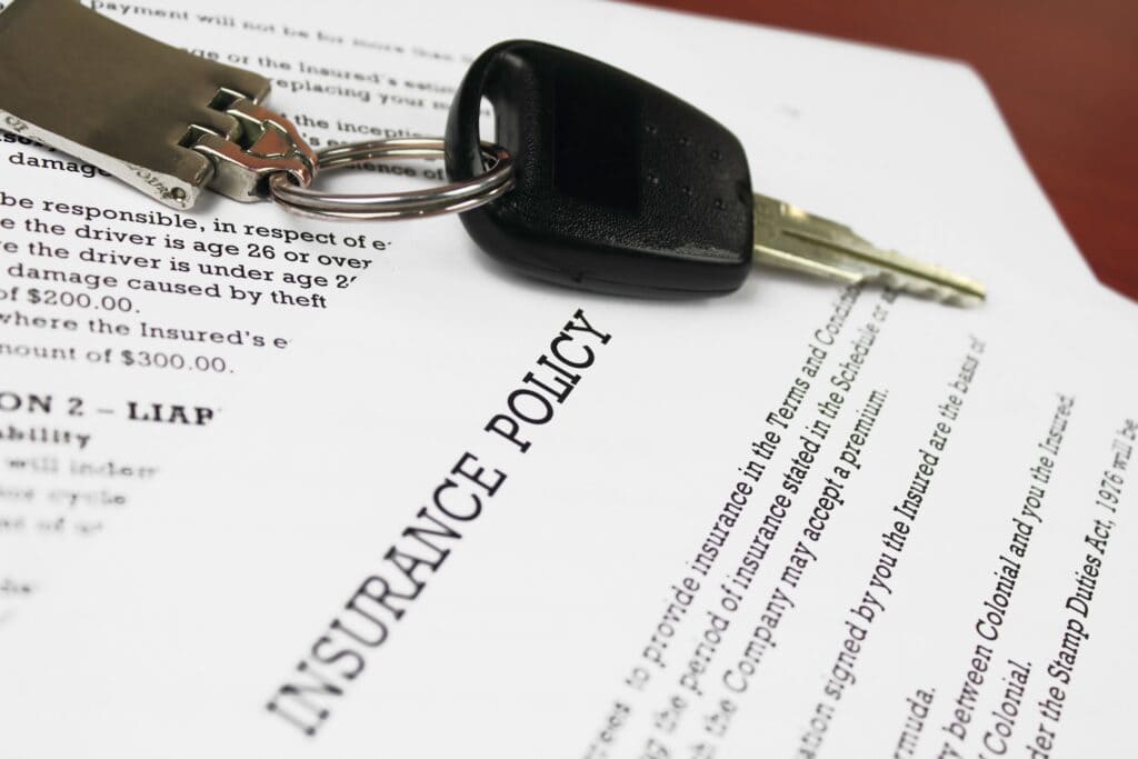 A view of insurance papers with a car key on it