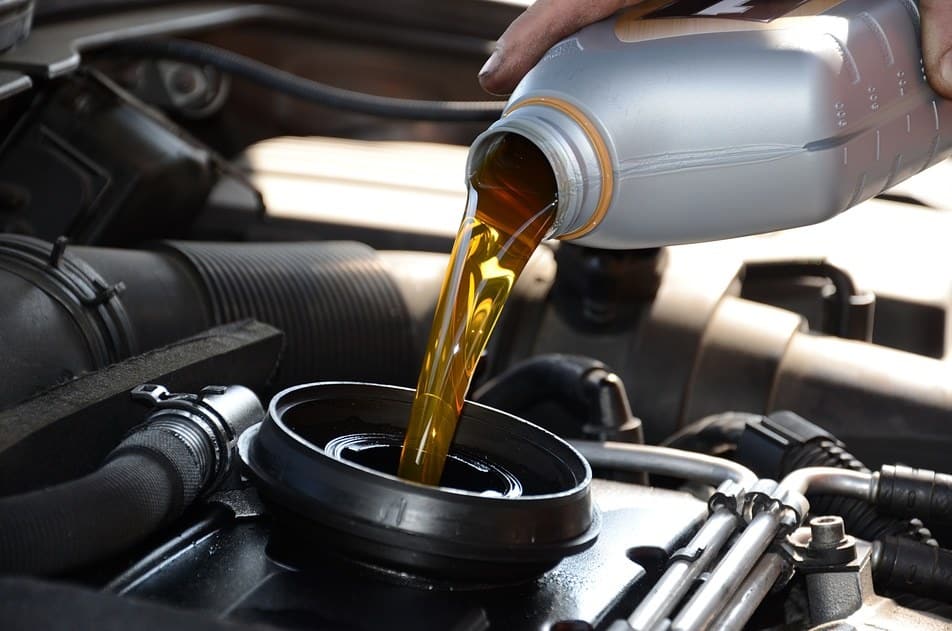 A view of oil being poured in a car engine