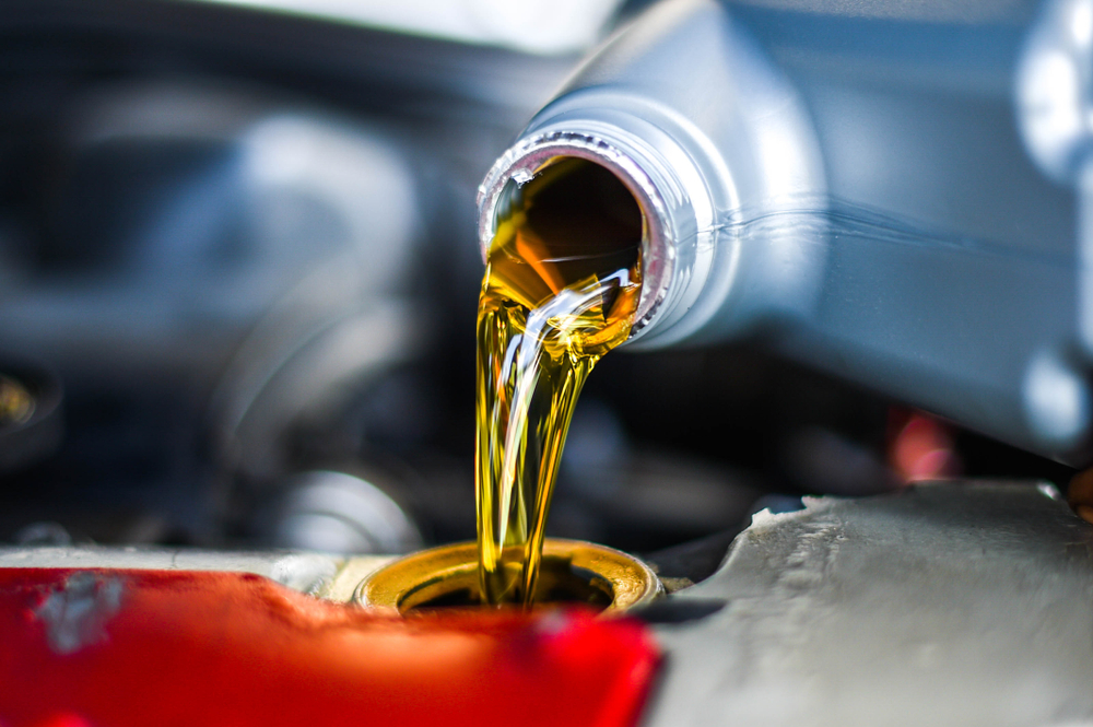 A view of oil pouring out of a bottle can