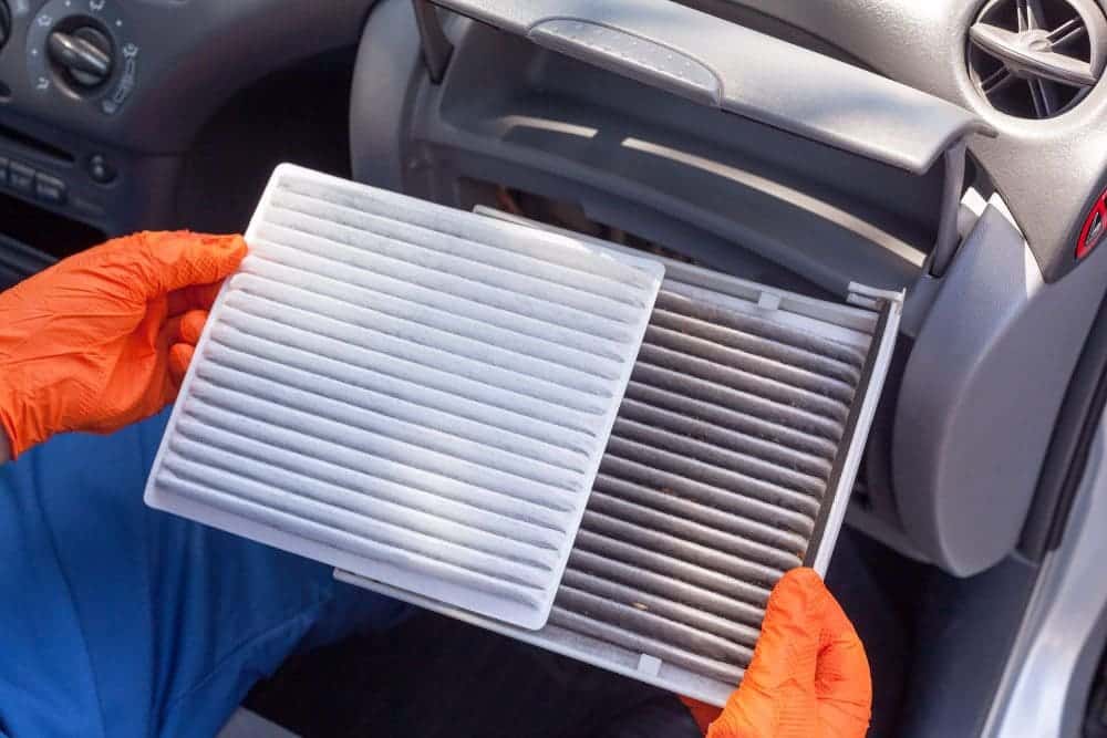 a person holding the car Ac air filters