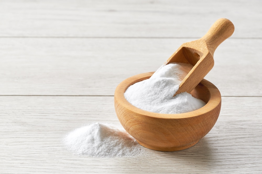 A view of baking soda in a wooden bowl