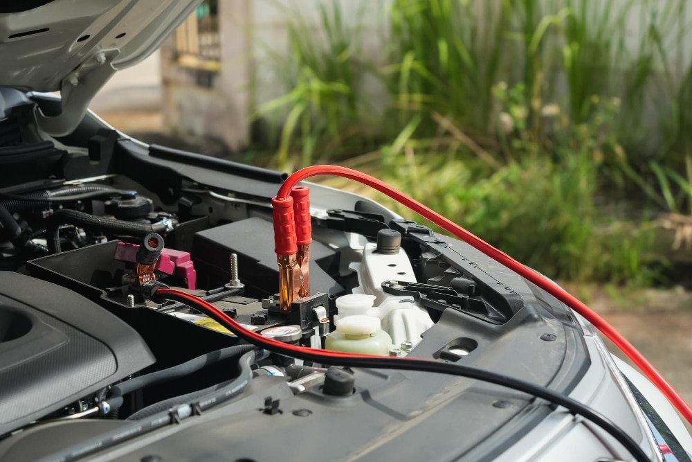 a jumper cable fitted in a car for jumpstart