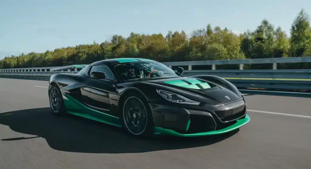 A view of a black and green sports car on road