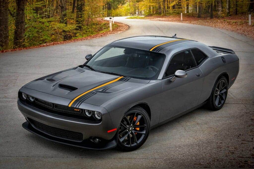 A view of a grey dodge challenger sports vehicle on road