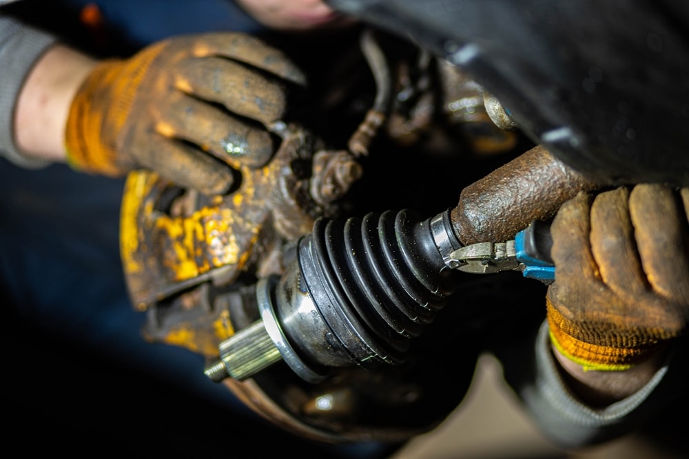 A view of a person holding a car axle