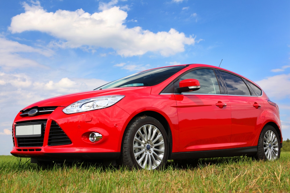 A view of a red car in grass