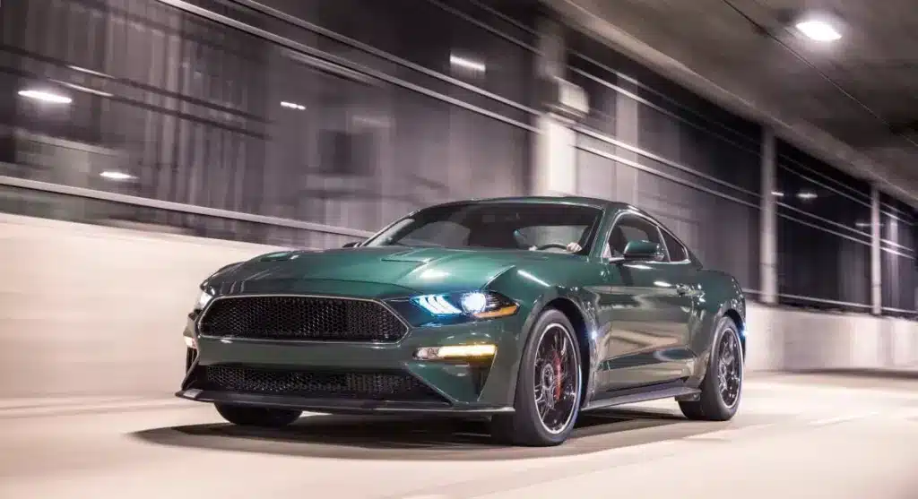 A view of a shiny green sports car speeding