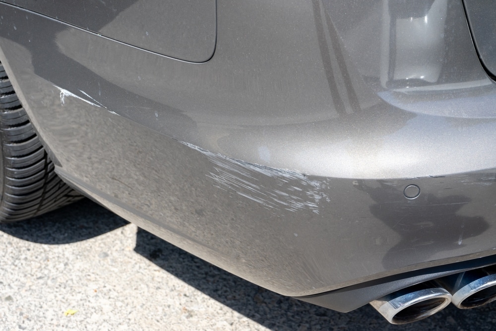 A view of a silver car with scratches