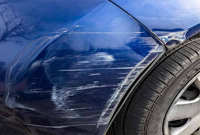 A view of scratches on a blue car