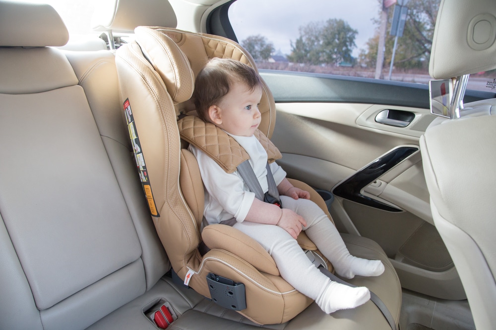 A view of a baby sitting in an infant car seat