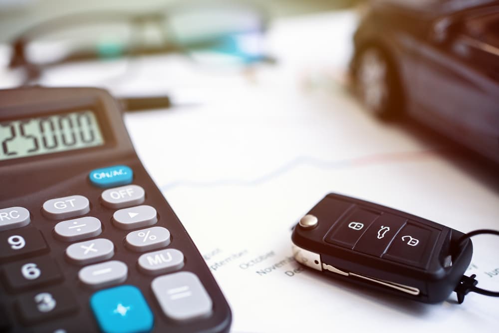 A view of a car key alongside a calculator