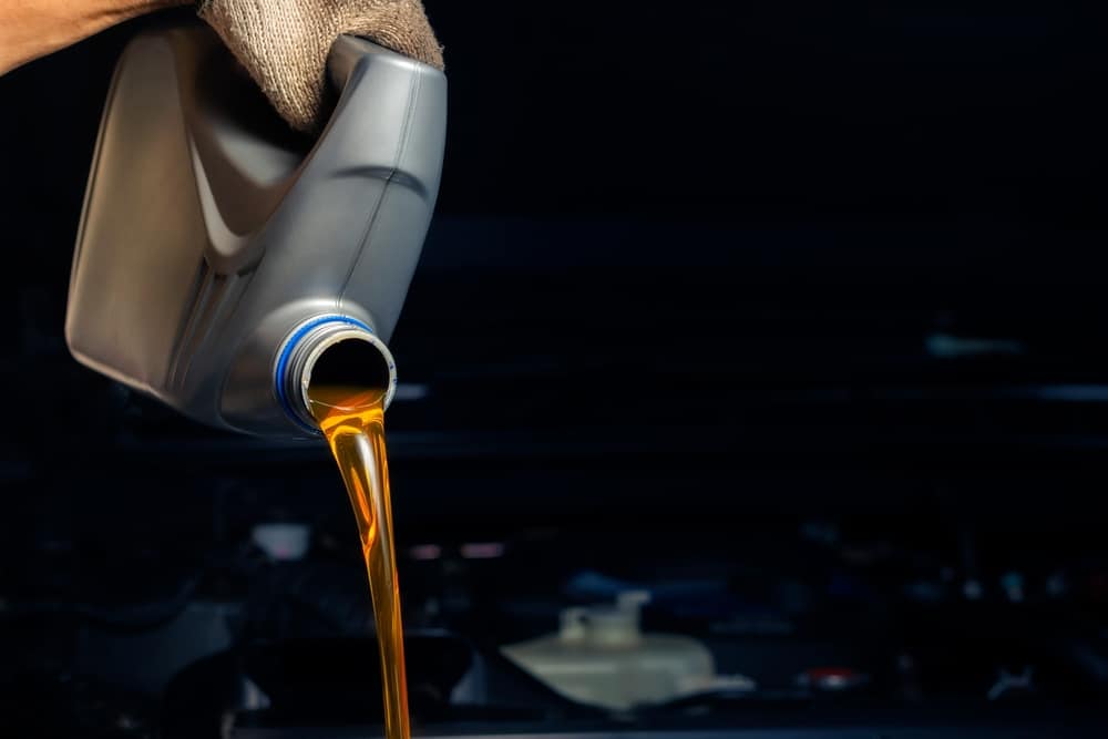 A view of a gallon of oil pouring car oil