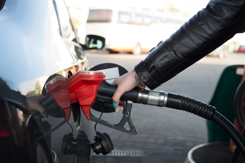 A view of a person refueling the car